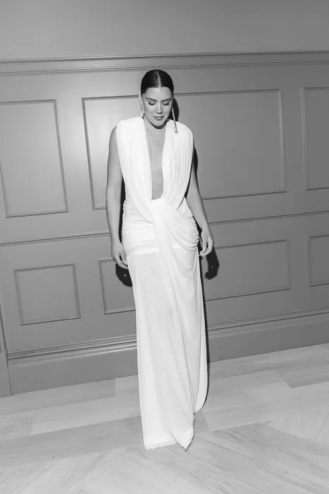 Bride in a modern wedding dress and veil standing inside the historic interiors of Boturich Castle.