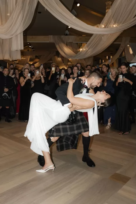 Groom lifting the bride during a lively dancefloor moment at Boturich Castle reception.