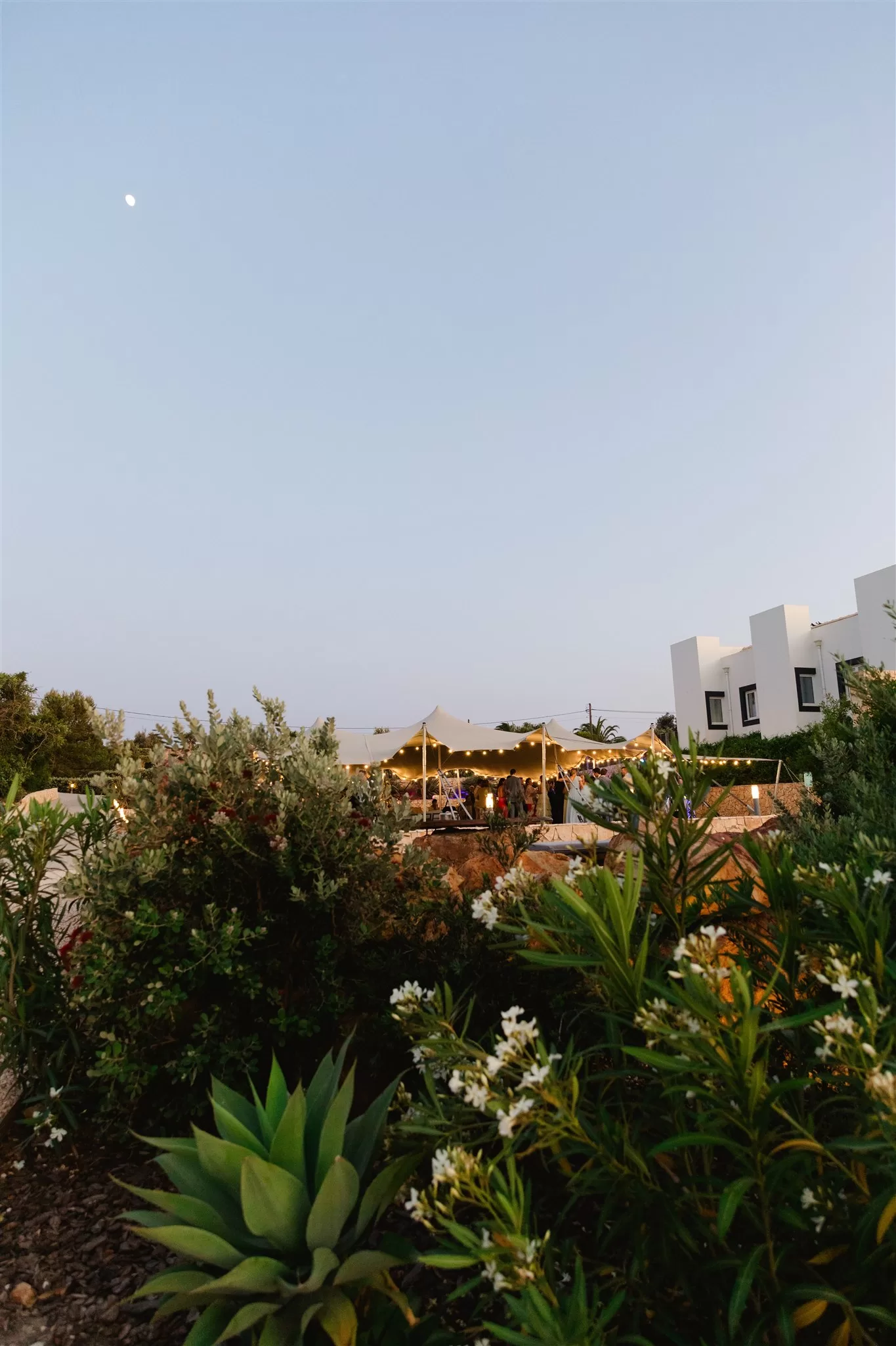 Wedding marquee glowing with festoon lights in the gardens of Casa Monte Cristo Collection during the evening celebration.
