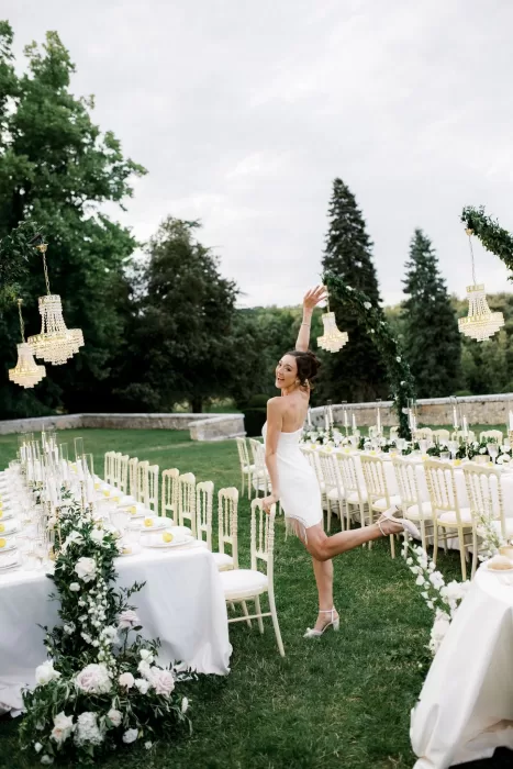 Elegant outdoor reception at Castello di Celsa with long banquet tables, chandeliers and floral arches on the lawn.