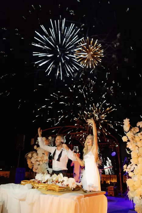 Newlyweds celebrating under fireworks during evening reception at Castello di Velona.