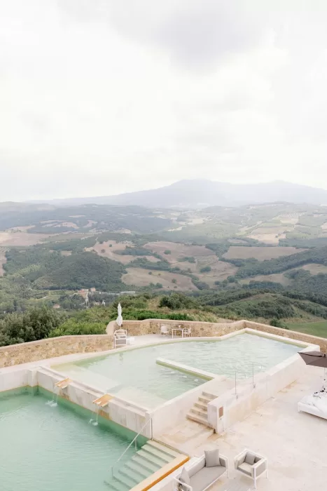 Panoramic thermal pool overlooking rolling Tuscan hills at Castello di Velona.