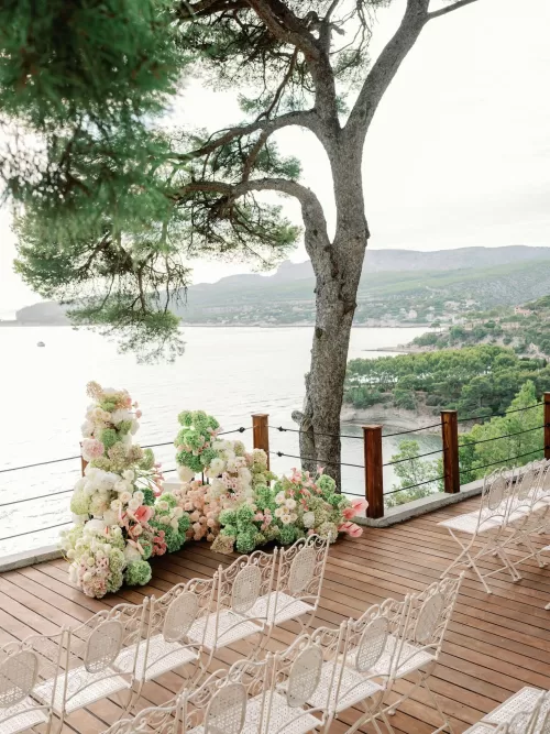 Overhead view of an evening wedding reception with long tables and cocktails at Domaine de Canaille