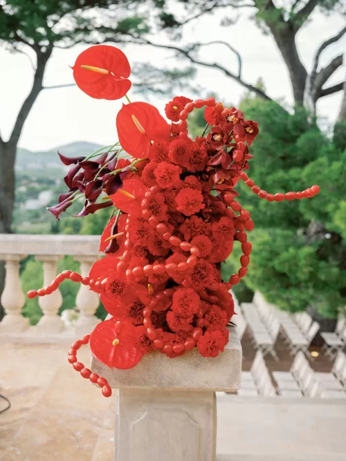 Bold red floral arrangement used as statement decor for a wedding at Domaine de Canaille
