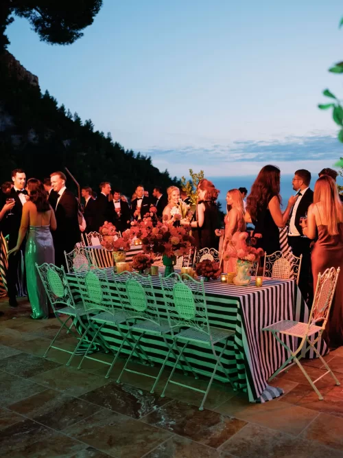 Sculptural tomato and floral centrepieces styled on a terrace at Domaine de Canaille.