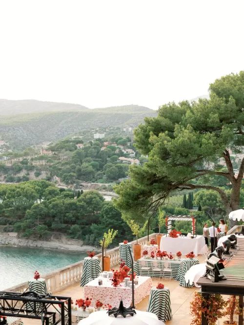 Wedding reception set up on the main terrace of Domaine de Canaille with guests and sea views