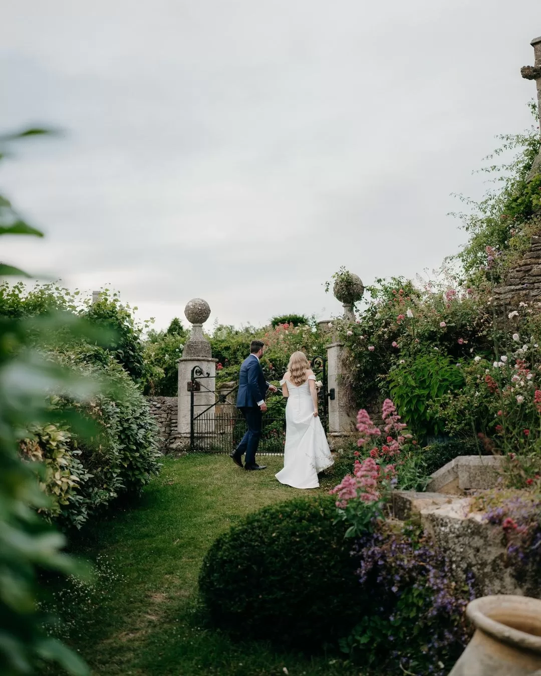 A picturesque countryside pathway leading to Euridge Manor, surrounded by vibrant greenery.