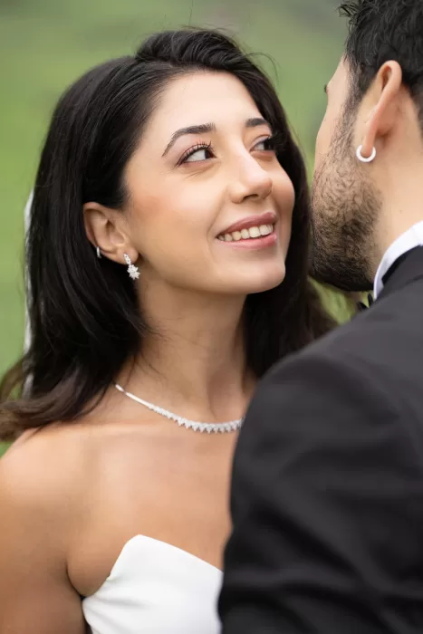 Close-up of a smiling bride wearing delicate diamond jewellery during her Villa Honegg wedding in Switzerland.