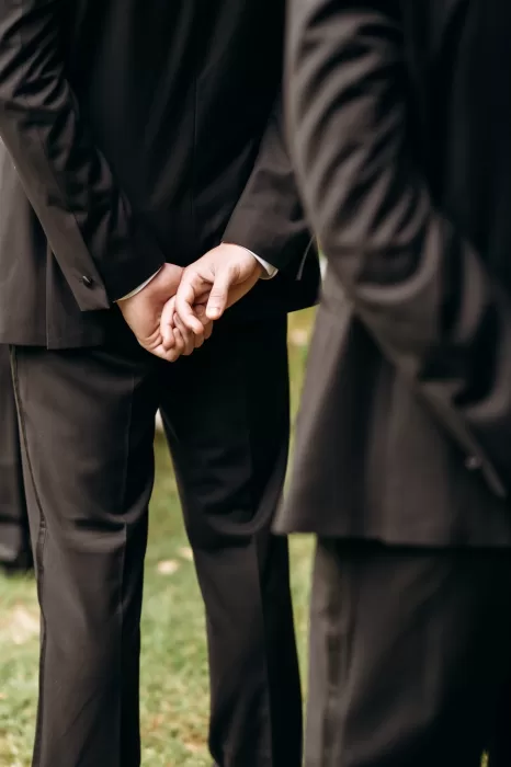 Groom standing with hands clasped waiting during ceremony at Castello di San Fabiano