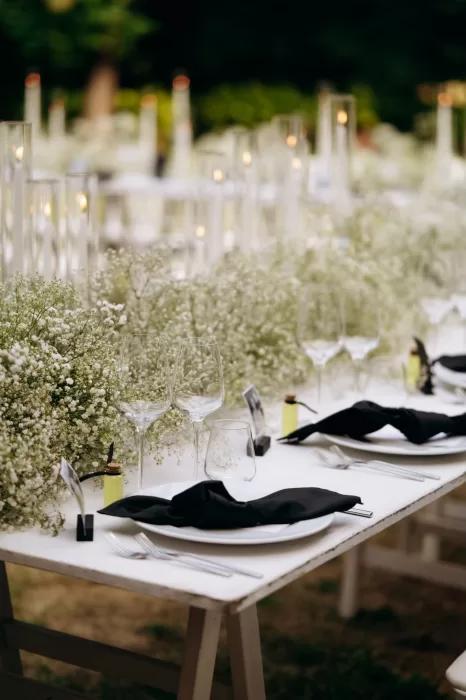 Reception table styled with candles, glassware and soft florals at Castello di San Fabiano