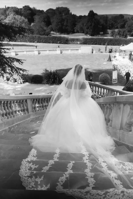 Black and white portrait of the bride on the grand outdoor staircase at Château Bouffémont.