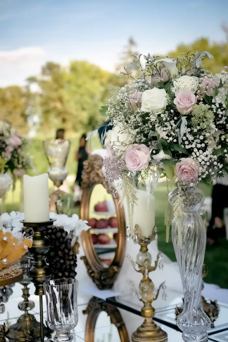 Elegant wedding table styling with pastel roses, candles and mirrored décor set on the grounds of Château Bouffémont.