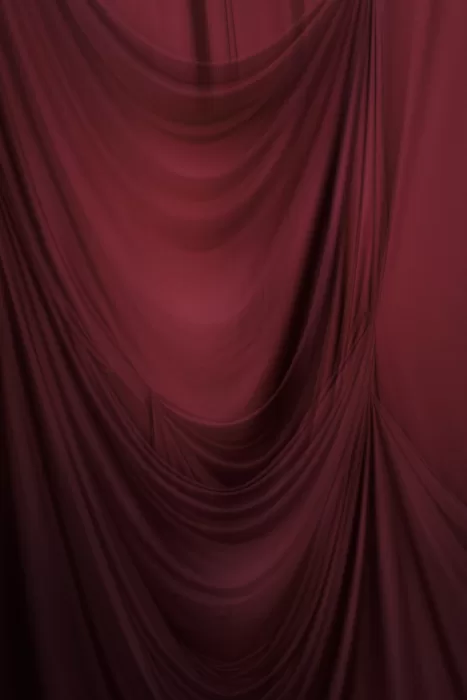 Rich burgundy drapery backdrop used for ceremony styling and portraits at Common Goods wedding venue.