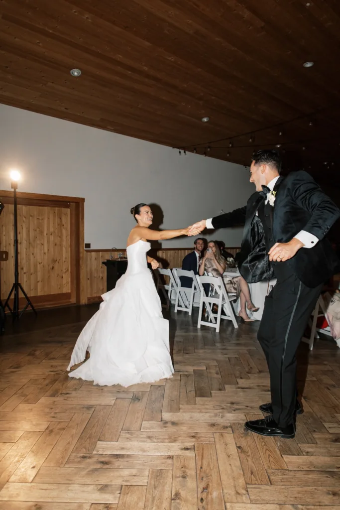 Bride and groom spinning on dance floor during reception at Fraser River Lodge