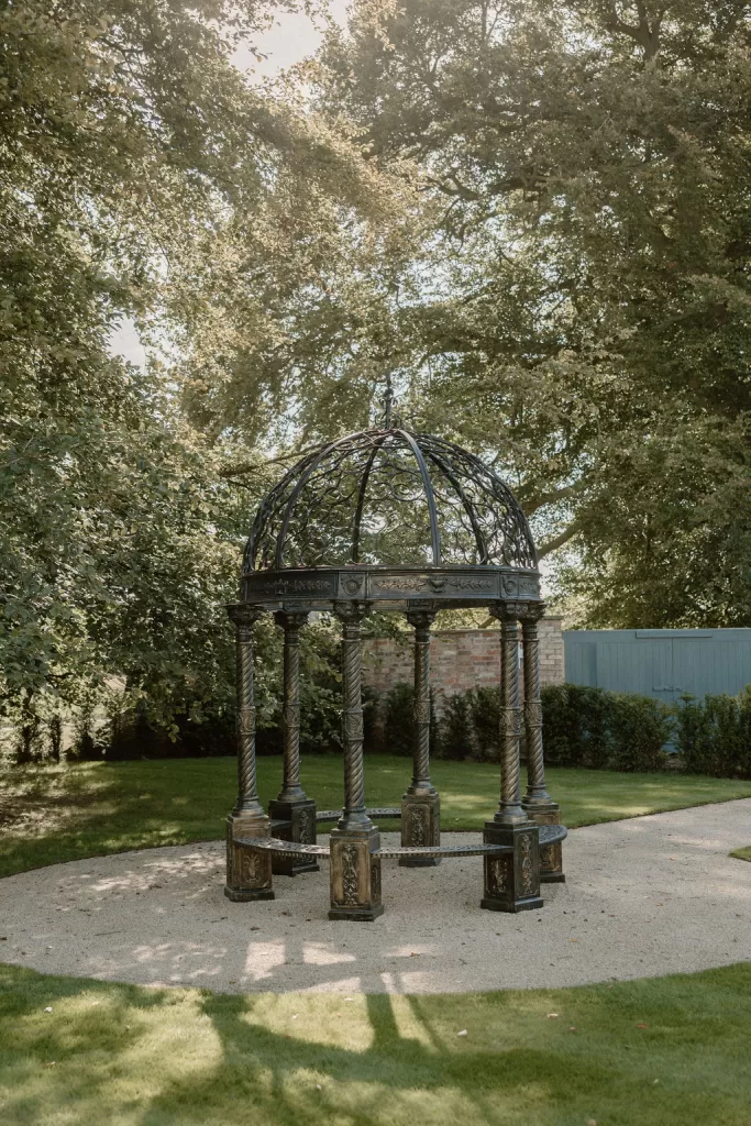 Ornate metal gazebo in landscaped gardens at Hotham Hall Estate