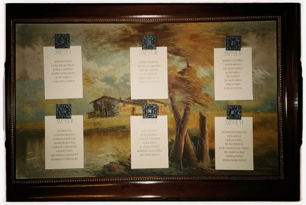 Framed wedding seating chart displayed for guests during the celebration at Infante Sagres.