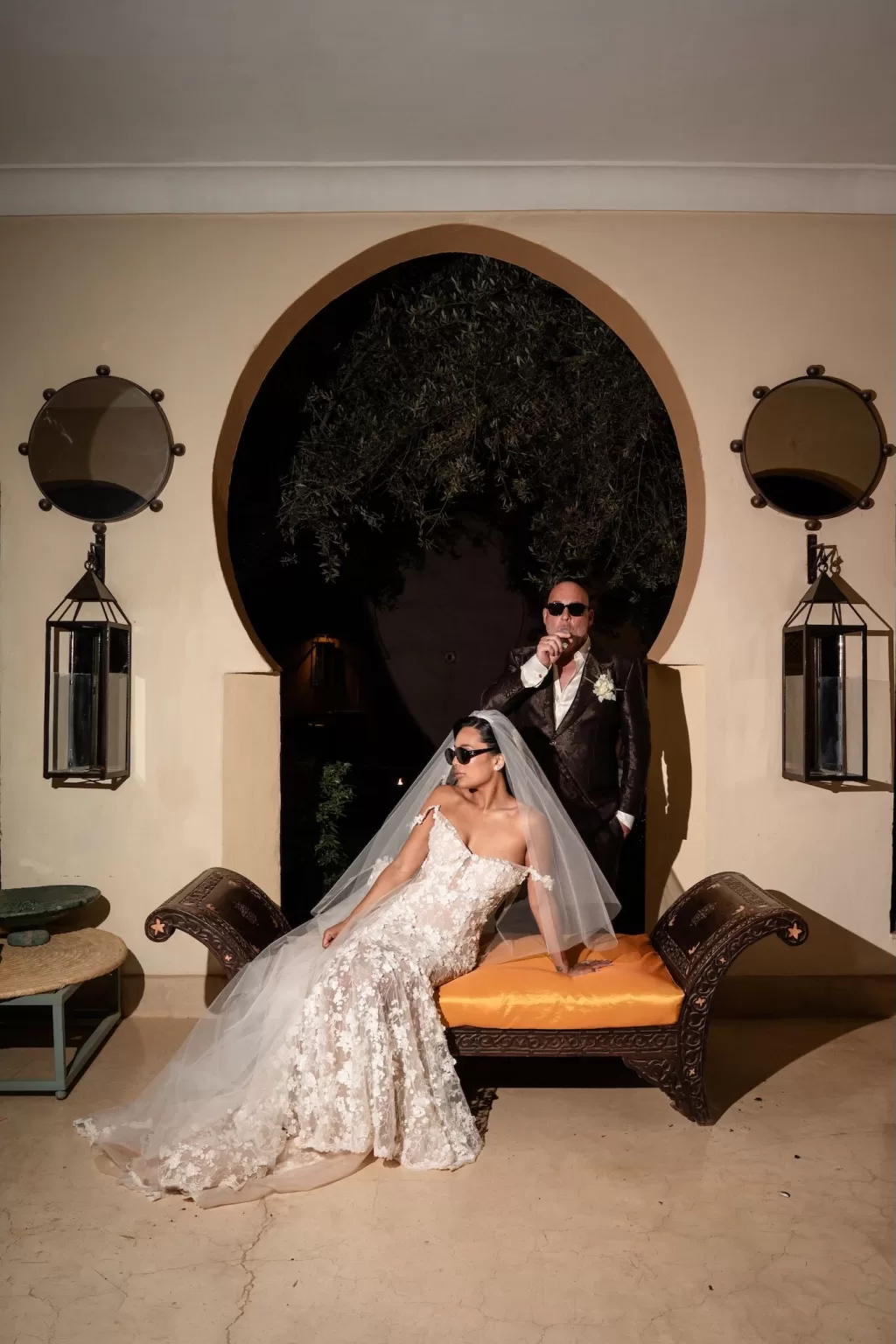 Bride and groom posing in sunglasses under an arched entrance at Jnane Tamsna, creating a chic editorial moment.