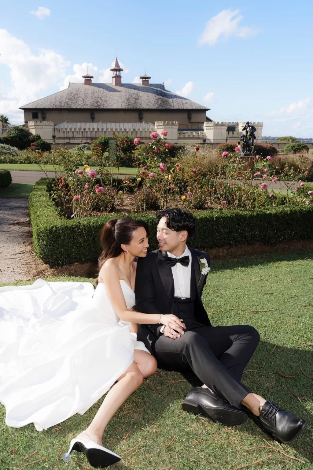 Bride and groom sitting in the garden at Next Chapter Events, smiling at each other.
