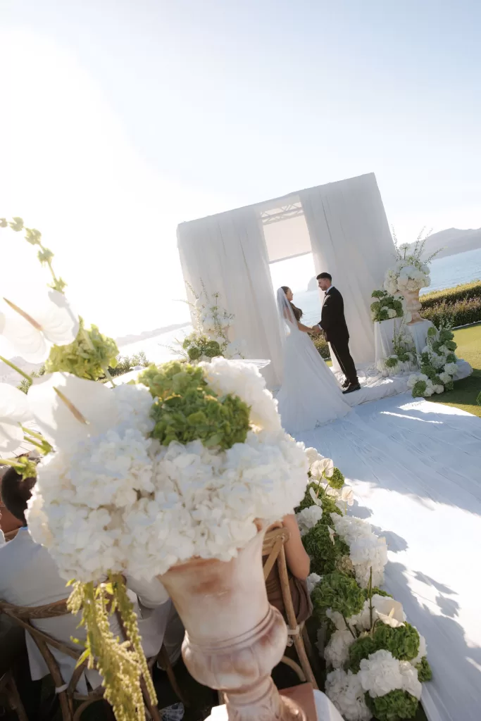 Close view of ceremony aisle and floral arrangements at Sea View by En Kipo during golden hour