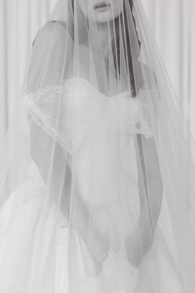 Soft bridal portrait through veil highlighting textured gown details at Studio Sunset Chicago