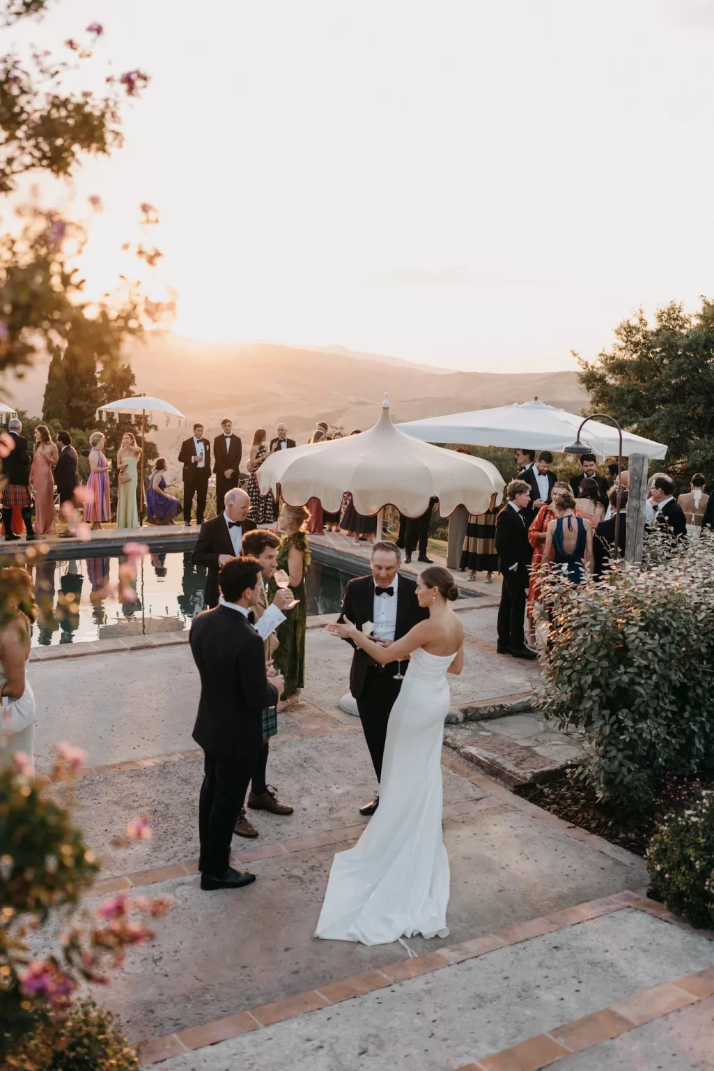 Poolside cocktail hour with Tuscan views by Cloud Eight Weddings