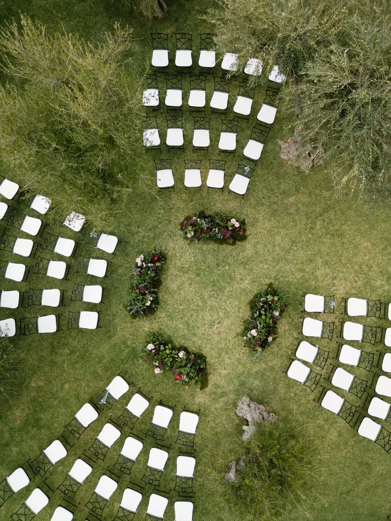 Aerial view of outdoor ceremony setup with chairs and floral arrangements at Finca Morneta