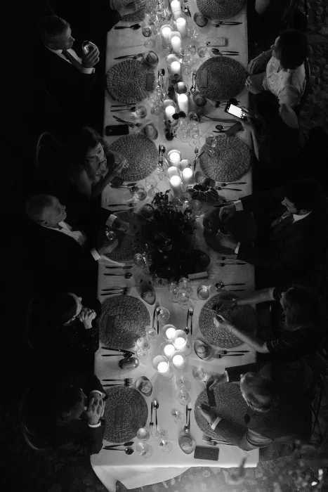 Guests seated around candlelit table during reception at Finca Morneta