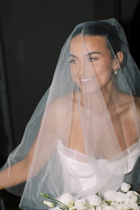 Close-up bridal portrait through veil with soft light at Fraser River Lodge