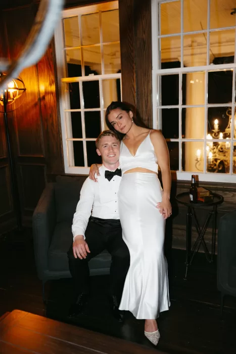 Evening portrait of the couple indoors at The Manor House with warm lighting and relaxed after-dark