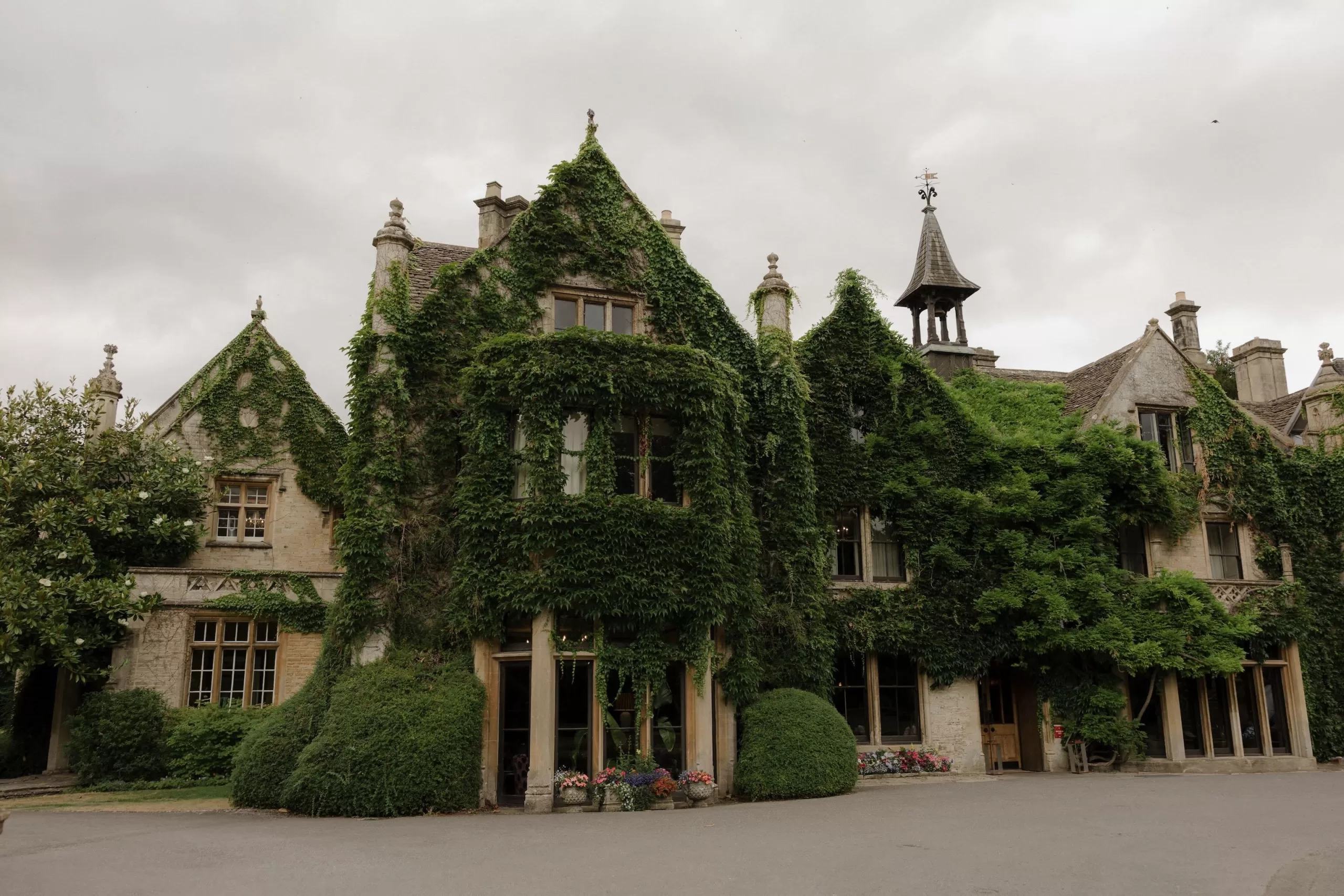 The ivy-covered façade of Manor House, a romantic countryside venue with historic charm.