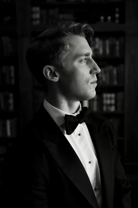 Black and white groom portrait in profile at The Manor House, photographed in elegant side light.