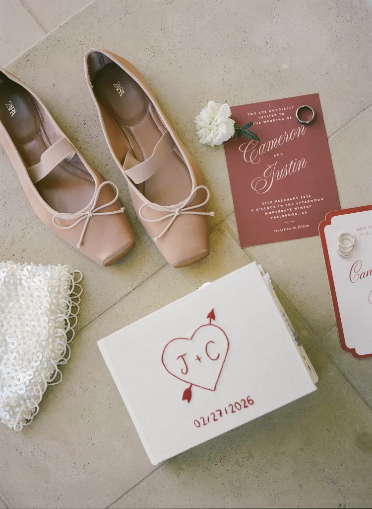 Bridal accessories, shoes and invitation suite styled on stone floor at Monserate Winery