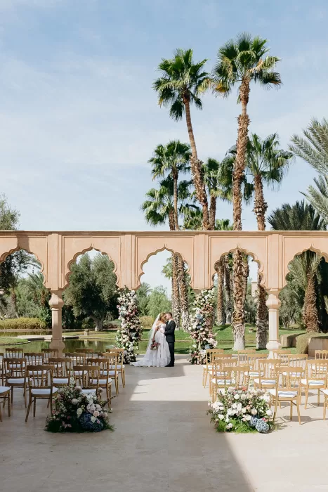 Outdoor wedding ceremony setup with floral arrangements and arches at Palais Namaskar