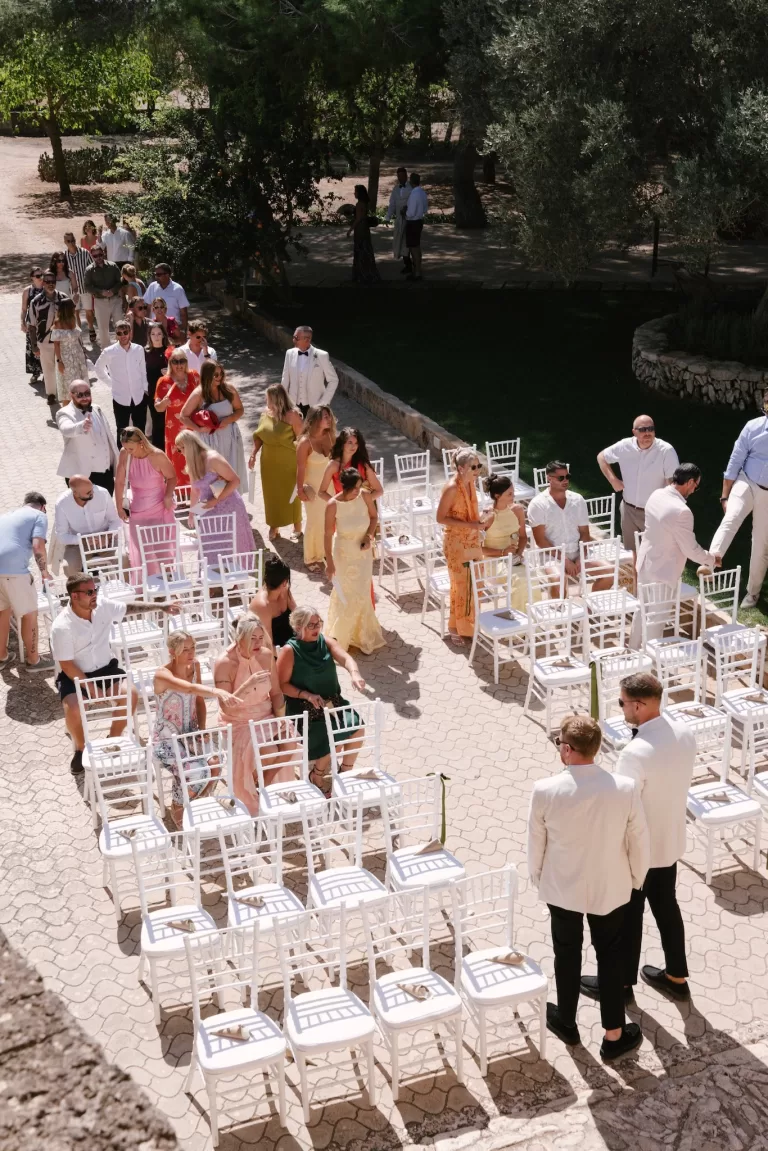 Wedding guests arriving and taking their seats in an outdoor Mallorca finca ceremony setting
