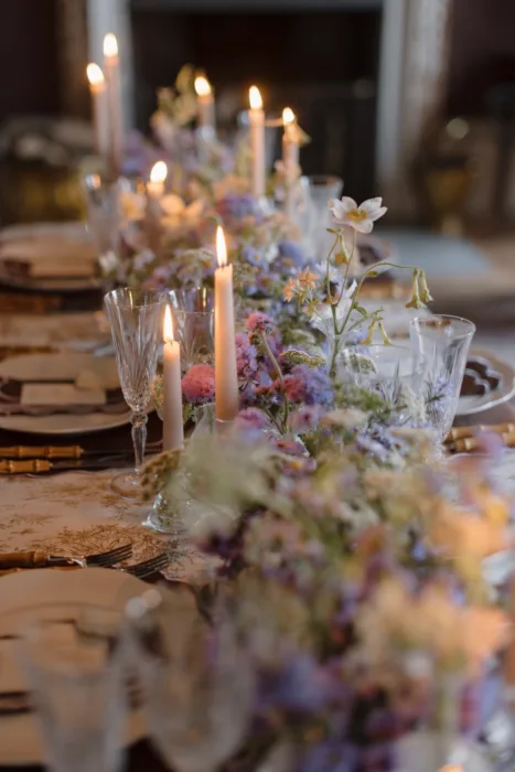 Candlelit reception table with pastel flowers, crystal glassware and delicate floral styling