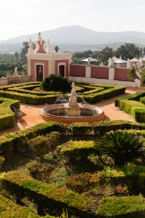 Formal gardens and fountain at Pousada Palácio Estoi overlooking the Algarve countryside