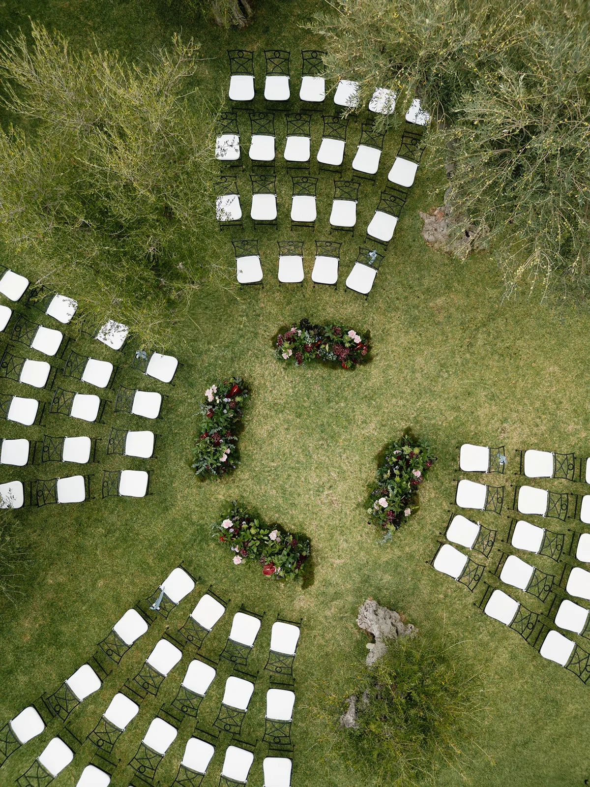 Aerial view of outdoor ceremony setup with chairs and floral arrangements at Finca Morneta